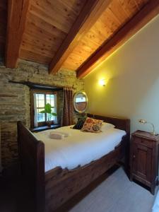 a bedroom with a large bed in a room at Albergo diffuso La Marmu Osteria della Croce Bianca in Marmora