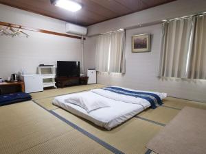 Postel nebo postele na pokoji v ubytování Business Hotel Azuma