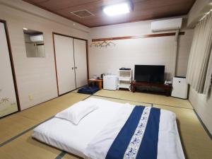 Postel nebo postele na pokoji v ubytování Business Hotel Azuma
