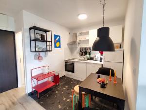a kitchen with a table and a dining room at Apartman Serbus-Zagreb in Zagreb