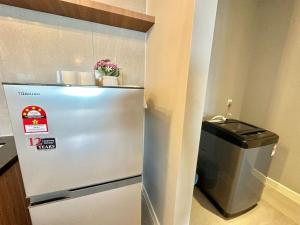 a stainless steel refrigerator in a room with a trash can at Imperio Residence Melaka in Melaka