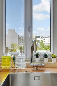 a kitchen counter with a sink and a window at Cosy Duplex in Boulogne-Billancourt