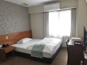 Postel nebo postele na pokoji v ubytování Business Hotel Azuma