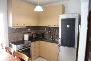 a kitchen with a stainless steel refrigerator and a table at 2ndHome in Perea