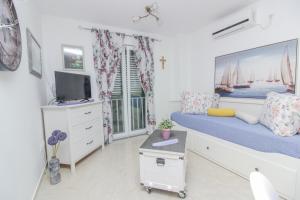 a bedroom with a large bed and a tv at New! Apartment Aenona 200m from the beach, Nin in Nin