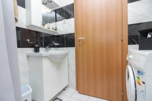 a bathroom with a sink and a washing machine at New! Apartment Aenona 200m from the beach, Nin in Nin +18 photos