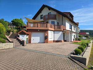 a large house with a large driveway in front of it at Ferienwohnung Jenny Edersee in Edersee