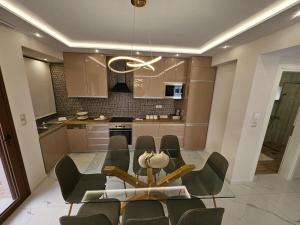a dining room with a glass table and chairs at Agora Luxury Villa I in Loutraki +31 photos