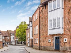 a brick building with a blue door on a street at Pass the Keys City Centre Town House w Parking in Chichester