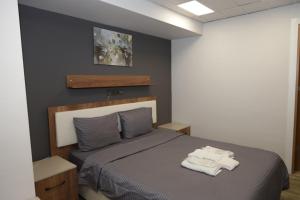 a bedroom with a bed with two towels on it at GÜNDOĞDU OTEL in Lapseki