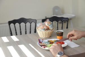 a person eating food on a table with a plate of food at GÜNDOĞDU OTEL in Lapseki +15 photos
