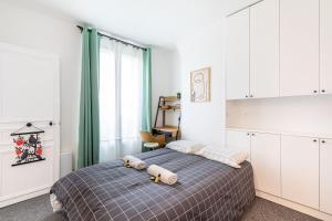 a bedroom with a bed with two pillows on it at GuestReady - A minimalist comfort in Vanves in Vanves