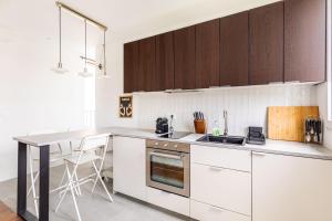 a kitchen with white cabinets and a counter top at GuestReady - A minimalist comfort in Vanves in Vanves