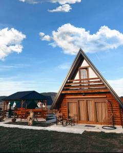 a log cabin with a picnic table and a gazebo at Durmitorski merak in Žabljak