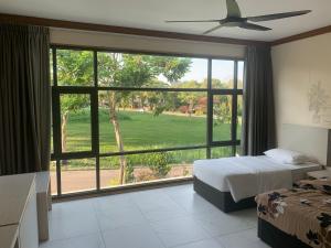 a bedroom with a bed and a large window at 2D Fantastic Villa Best HomeStay in Kampong Alor Gajah
