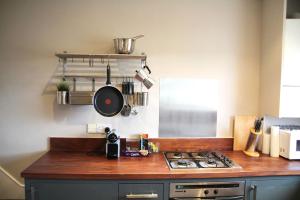 a kitchen with a counter top with a stove at GuestReady - Quaint English Flat near Portobello in London