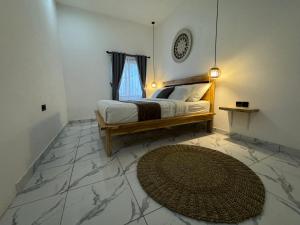 1 dormitorio con cama y alfombra grande en Santai Retreat, en Kuta Lombok