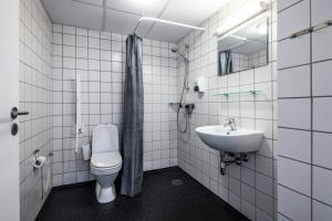 a bathroom with a toilet and a sink at HOTEL SØMA Ilulissat in Ilulissat