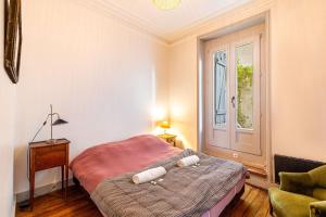 a bedroom with a bed and a window at GuestReady - Charming Getaway with Terrace in Paris