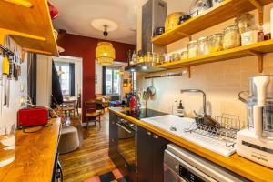a kitchen with a sink and a counter top at GuestReady - Charming Getaway with Terrace in Paris