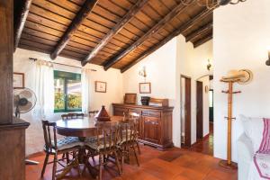 a dining room with a wooden table and chairs at GuestReady - Carvalhal Residence near Pego Beach in Comporta