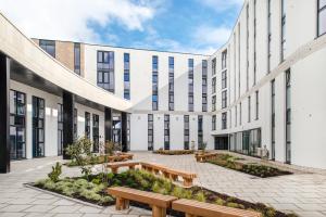 an office building with benches in the courtyard at Destiny Student - Holyrood (Brae House) in Edinburgh