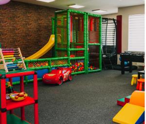 a play room with a toy car and a slide at LOFT Home in Daugavpils