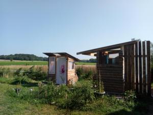 a small house in the middle of a field at Scout-2 in Le Fay