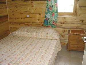 a bedroom with a bed in a log cabin at Val Pierre in Châtel