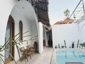 a courtyard with a swimming pool in a house at La PAYANA House Penida in Toyapakeh