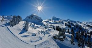a snow covered mountain with the sun in the sky at Val Pierre in Châtel