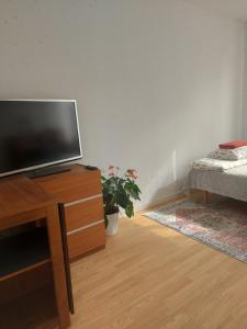 a living room with a flat screen tv on a dresser at feel like your own home in Linköping