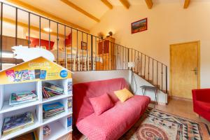sala de estar con sofá rosa y escalera en Lou Recati La Ribelle En Provence, en LʼIsle-sur-la-Sorgue