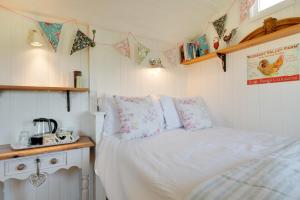 a bedroom with a bed in a small room at The Shepherds Hut in Holburn
