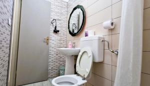a small bathroom with a toilet and a mirror at 3 Mini Studios in Siniscola in Siniscola +19 photos