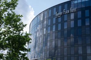 ein Glasgebäude mit einem Schild darauf in der Unterkunft Airport Plaza Hotel Hamburg in Norderstedt