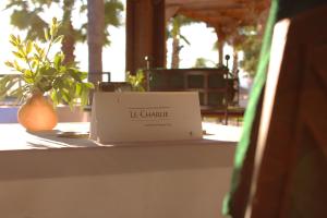 a box sitting on a table with a plant at Bella Vista Hôtel, Suites & Maisons in Porticcio