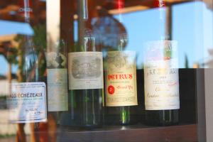a bunch of wine bottles sitting on a shelf at Bella Vista Hôtel, Suites & Maisons in Porticcio