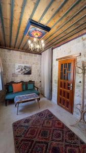 a living room with a couch and a rug at Elysee Cave House in Göreme