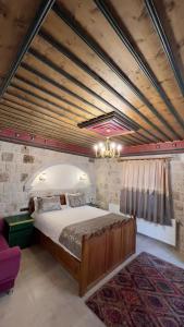 a bedroom with a large bed in a room at Elysee Cave House in Goreme