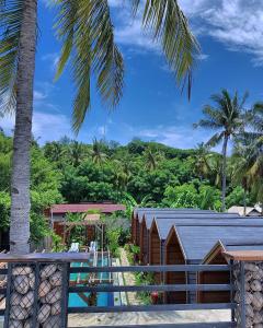 uma vista para um resort com uma palmeira em Absolute Villa em Gili Trawangan