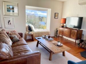 a living room with a couch and a coffee table at The Mod Clunes in Clunes