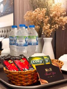 a tray with a basket of chips and bottles of water at M&H Hotel in Ho Chi Minh City