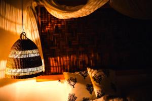 a room with a bed with a lamp and a bird cage at Sea Side Studios & Houses in Kalo Livadi