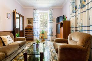 a living room with two couches and a glass table at Sweet Honey Home by Halldis in Dongo