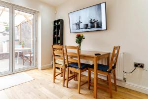 a dining room with a wooden table and chairs at Quiet Private Homestay, Central Birmingham in Birmingham