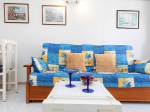 a living room with a blue couch and a table at Apartment Ancora by Interhome in Salou
