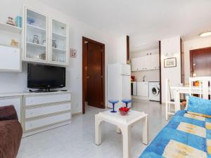 a living room with a couch and a tv and a table at Apartment Ancora by Interhome in Salou +15 photos