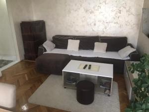 a living room with a couch and a table at Apartman Bazar in Smederevo