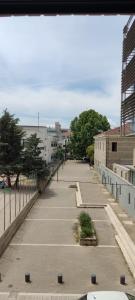 an empty street in a city with buildings at 3 Brothers III - sense of grey in Tríkala